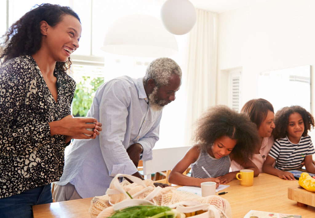 Multigenerational family playing game at table