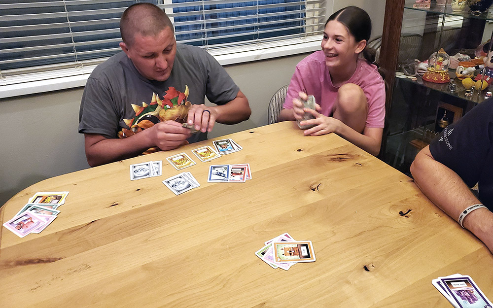 Family playing card game at table - Grandpa Beck's Games - FunFamilyGameNight.com